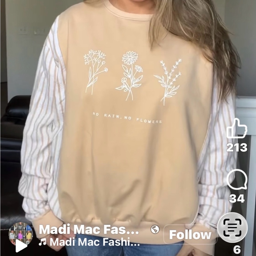 Reworked up-cycled sweatshirt with flannel sleeves by Madi Mac Fashions.